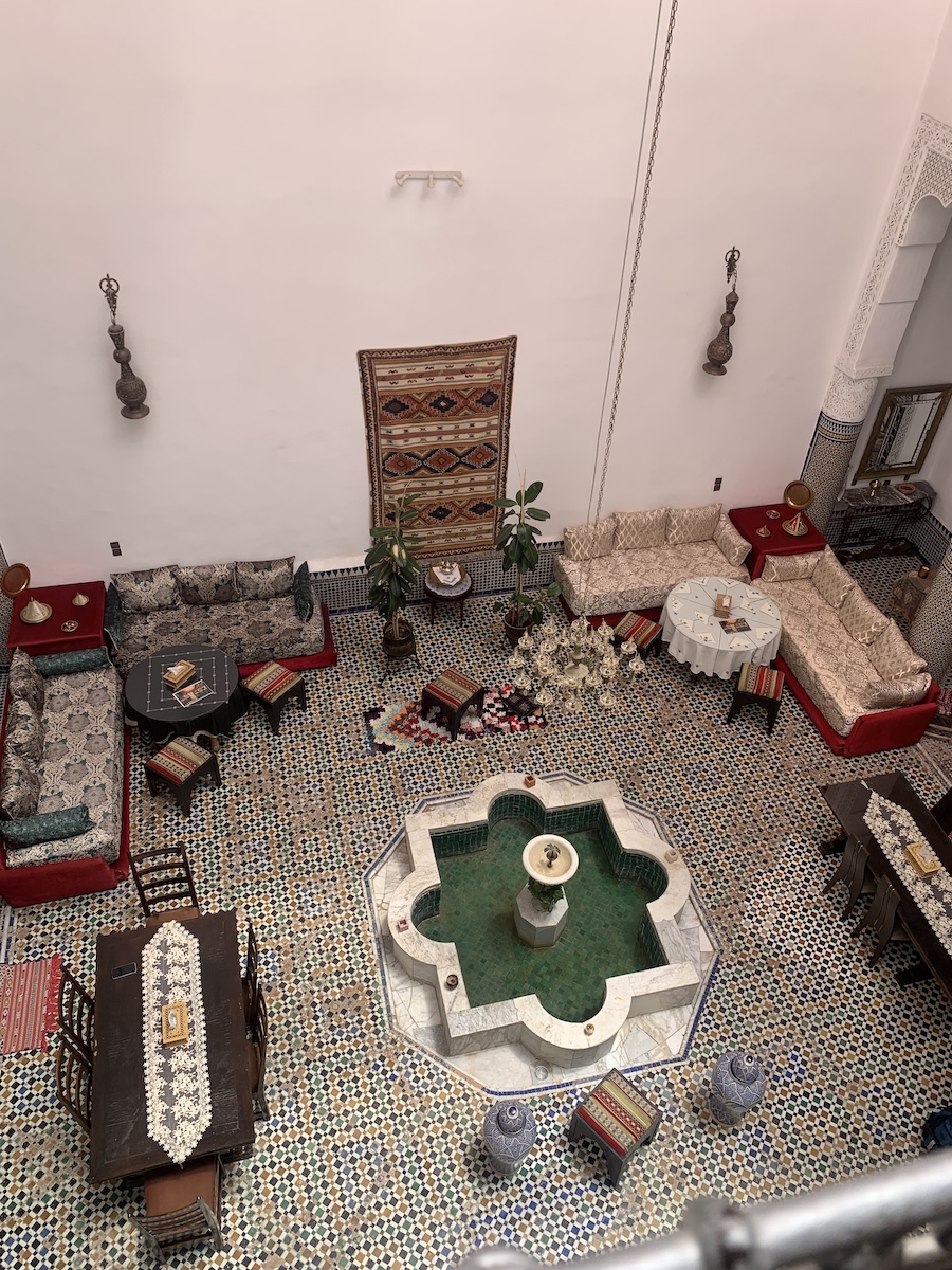 A courtyard with furniture and tiled floor