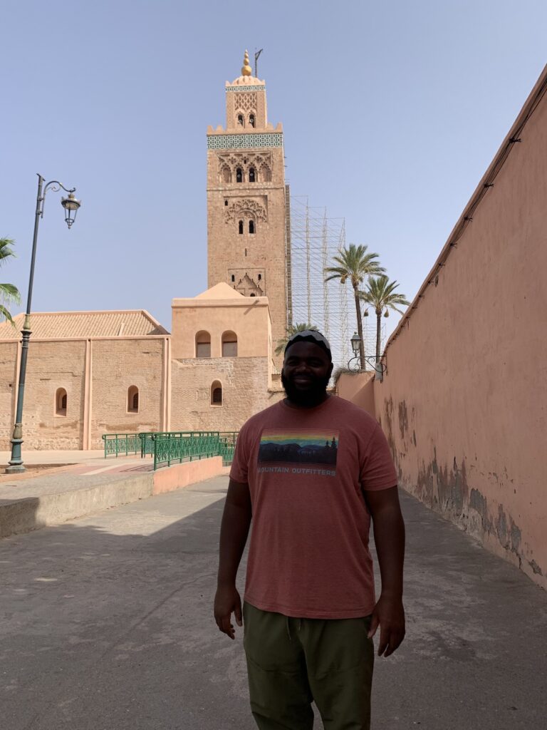 Man in front of a mosque