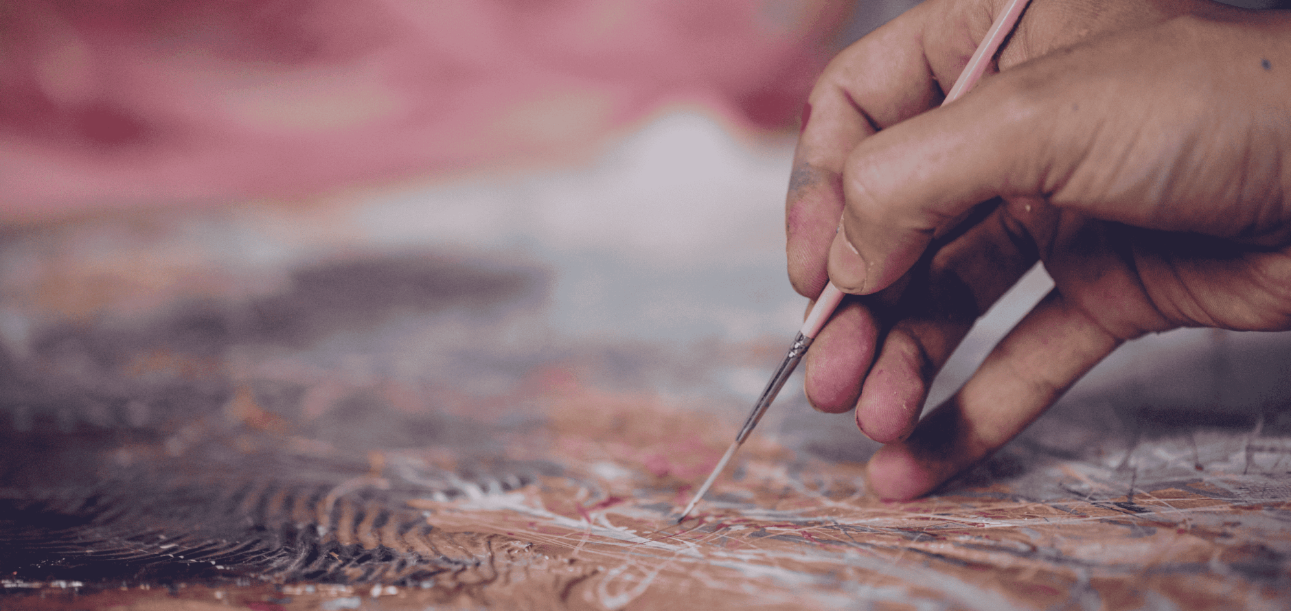 Close up of artist working on a painting in a studio