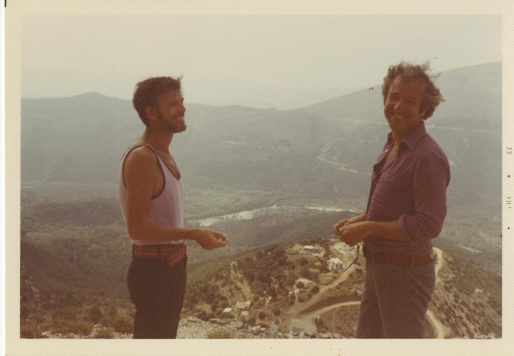 Two men standing above a valley