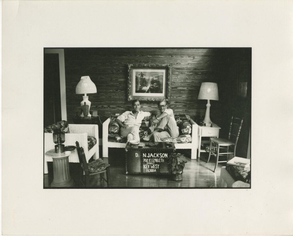 Two men on a couch in a living room