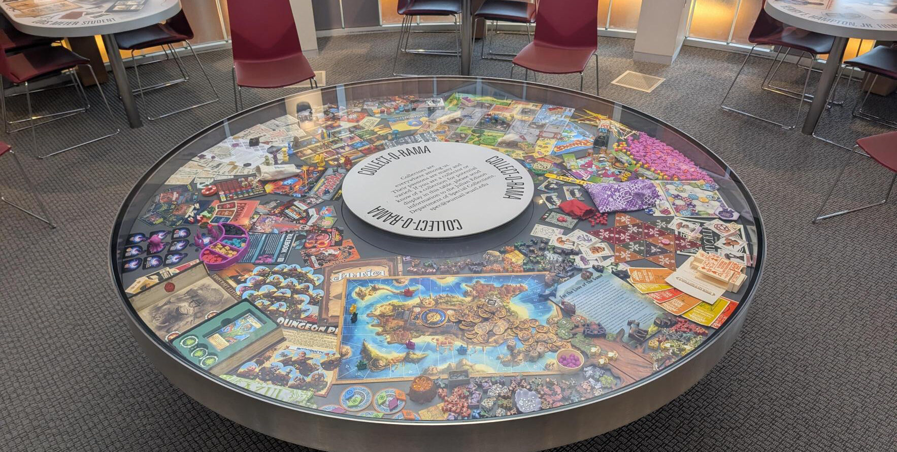 The Collect-O-Rama case in Olin Library with with various board games and associated dice and playing cards.
