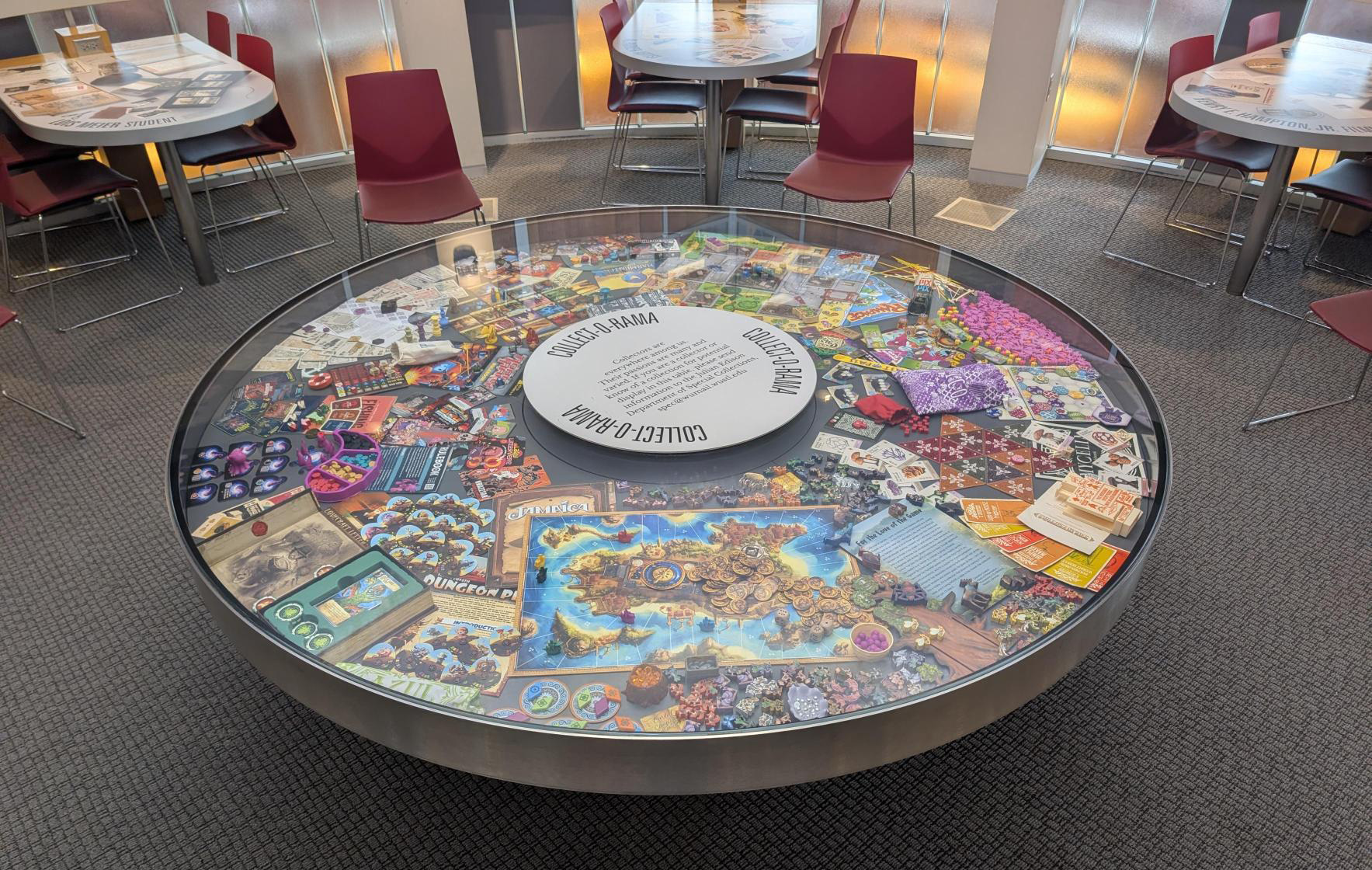The Collect-O-Rama case in Olin Library with with various board games and associated dice and playing cards.