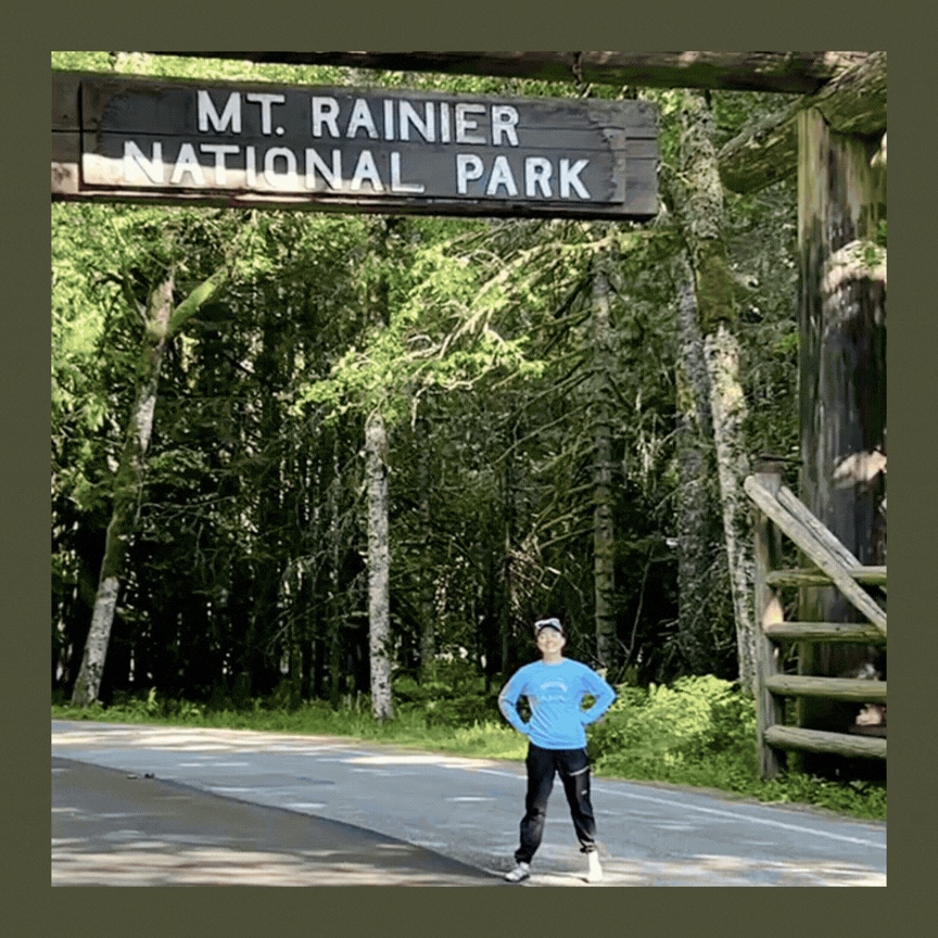 Person standing under a park sign