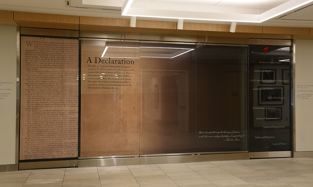 The exterior of the Declaration Chamber in Olin Library. The chamber glass is wrapped with an image of the back of the Declaration.