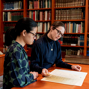 A reference librarian and researcher review materials in the Special Collections Reading Room.