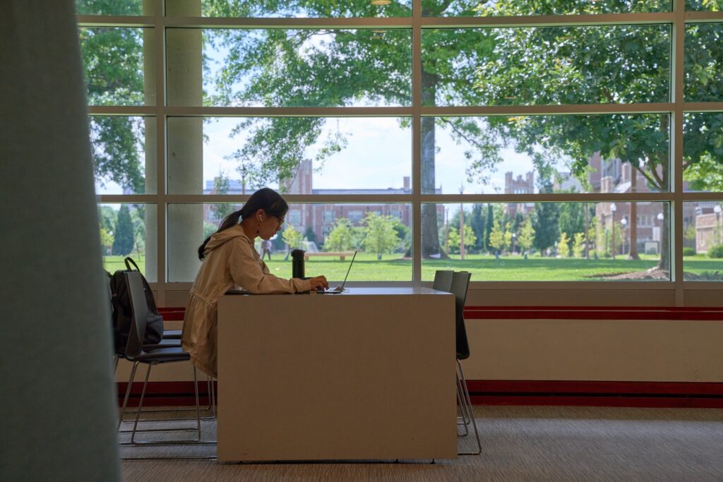 Student studying at a desk in Olin Library