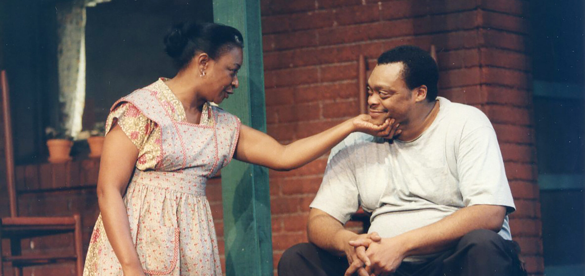 Two performers on stage during a play.