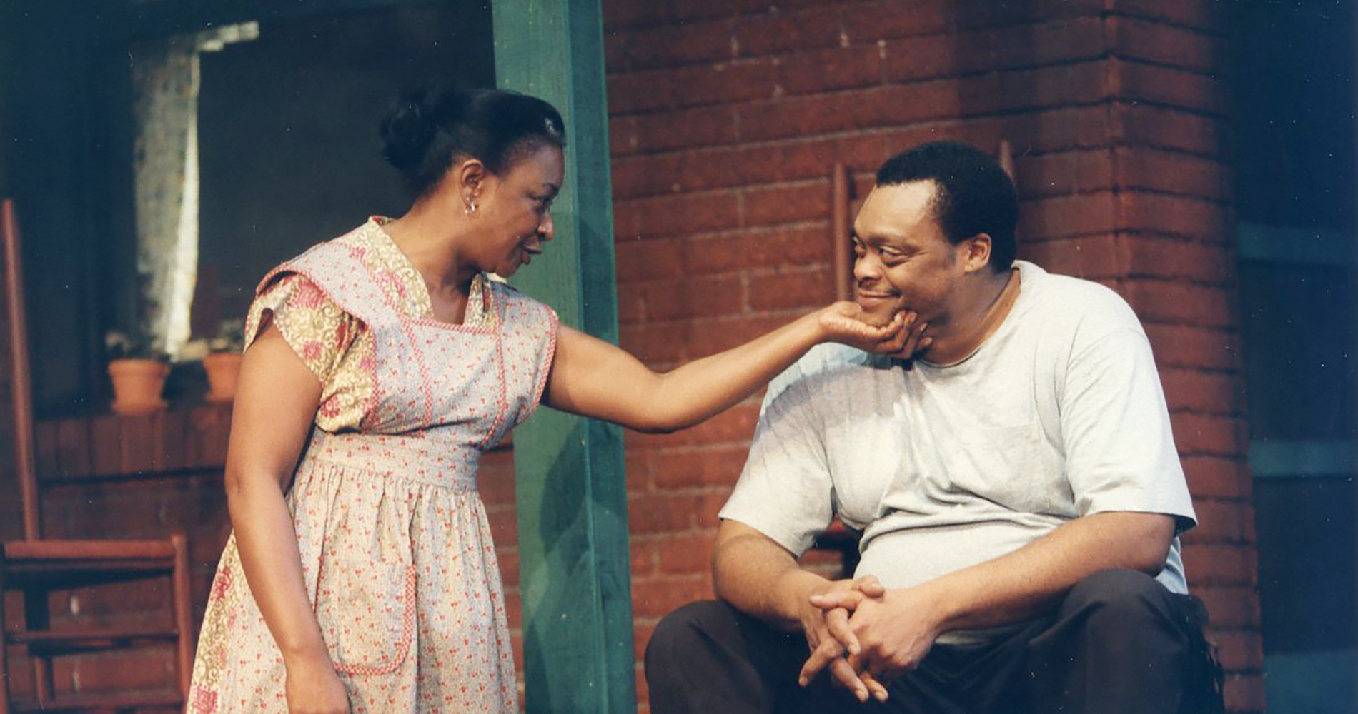 Two performers on stage during a play.